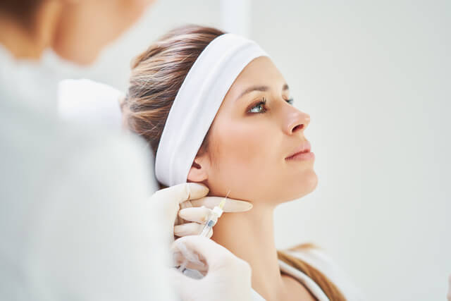 Close-up of a woman receiving a masseter Botox injection for jawline slimming at a medspa in Hot Springs