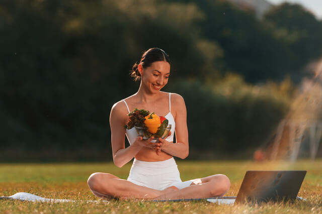 Woman holding fresh vegetables representing skin health and nutrition in Hot Springs AR