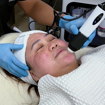 Dr. John Mark Pabona providing a Celestial Glow and Sculpt facial treatment at Embrace Eternal Beauty